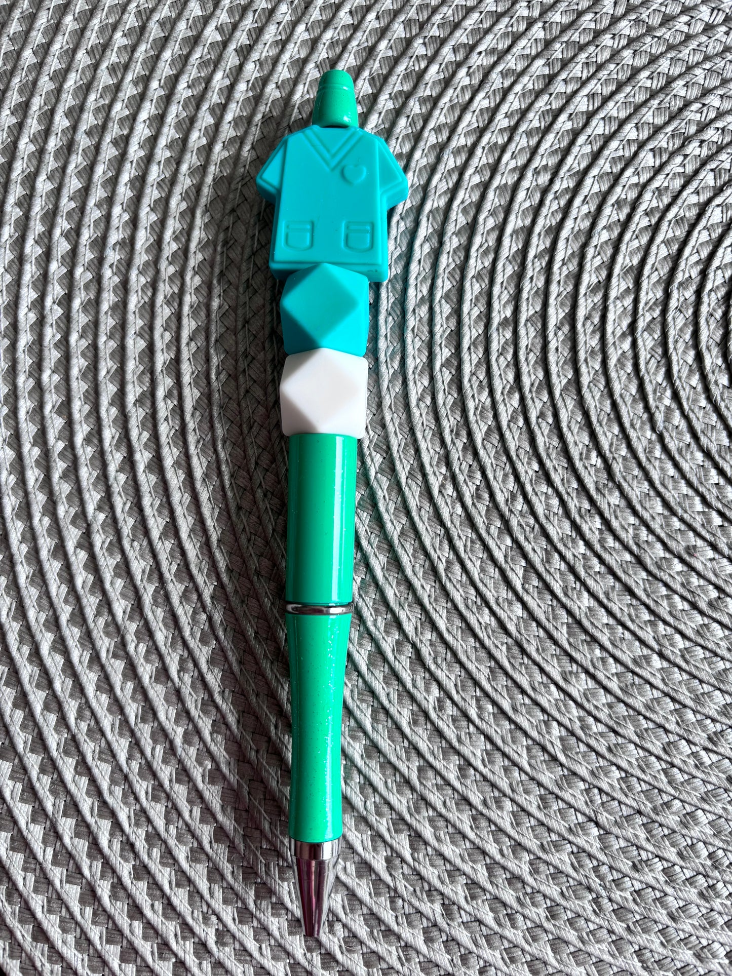 Teal scrub top pen