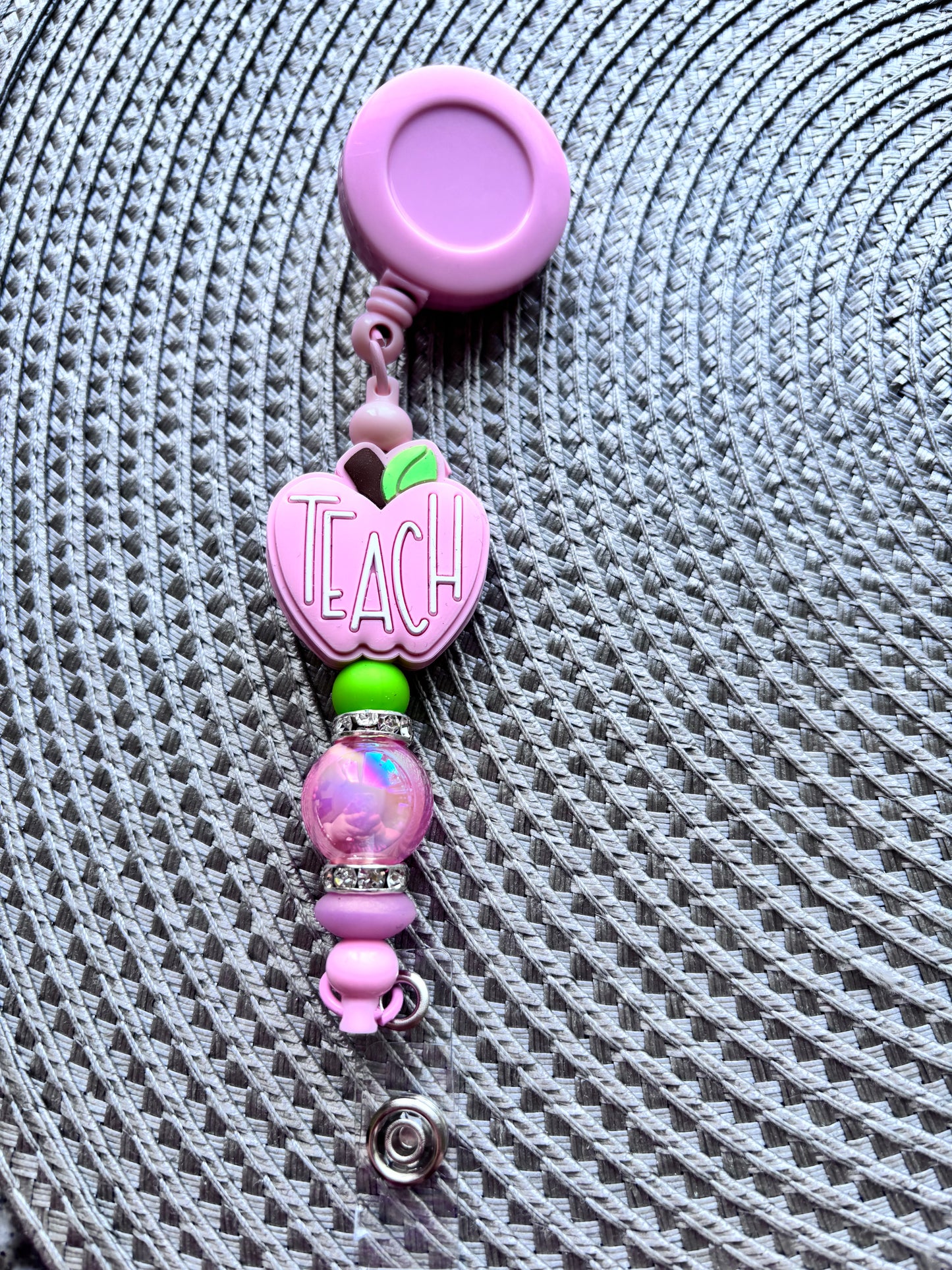 Pink apple teach badge reel